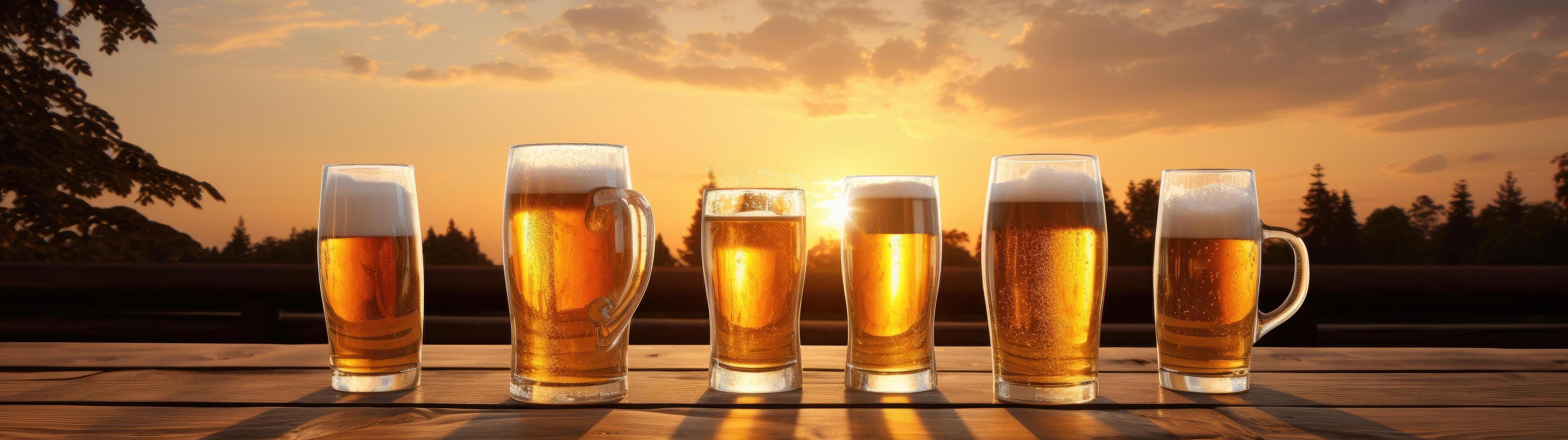Glasses of golden beer at sunset photo