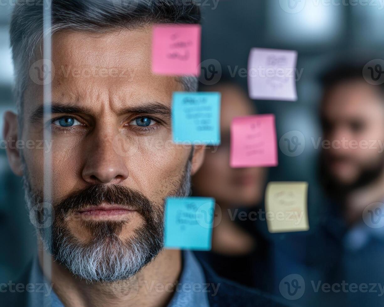 Thoughtful businessman with sticky notes on face photo