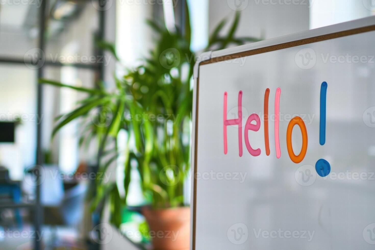 Colorful greeting on whiteboard with plants in office photo