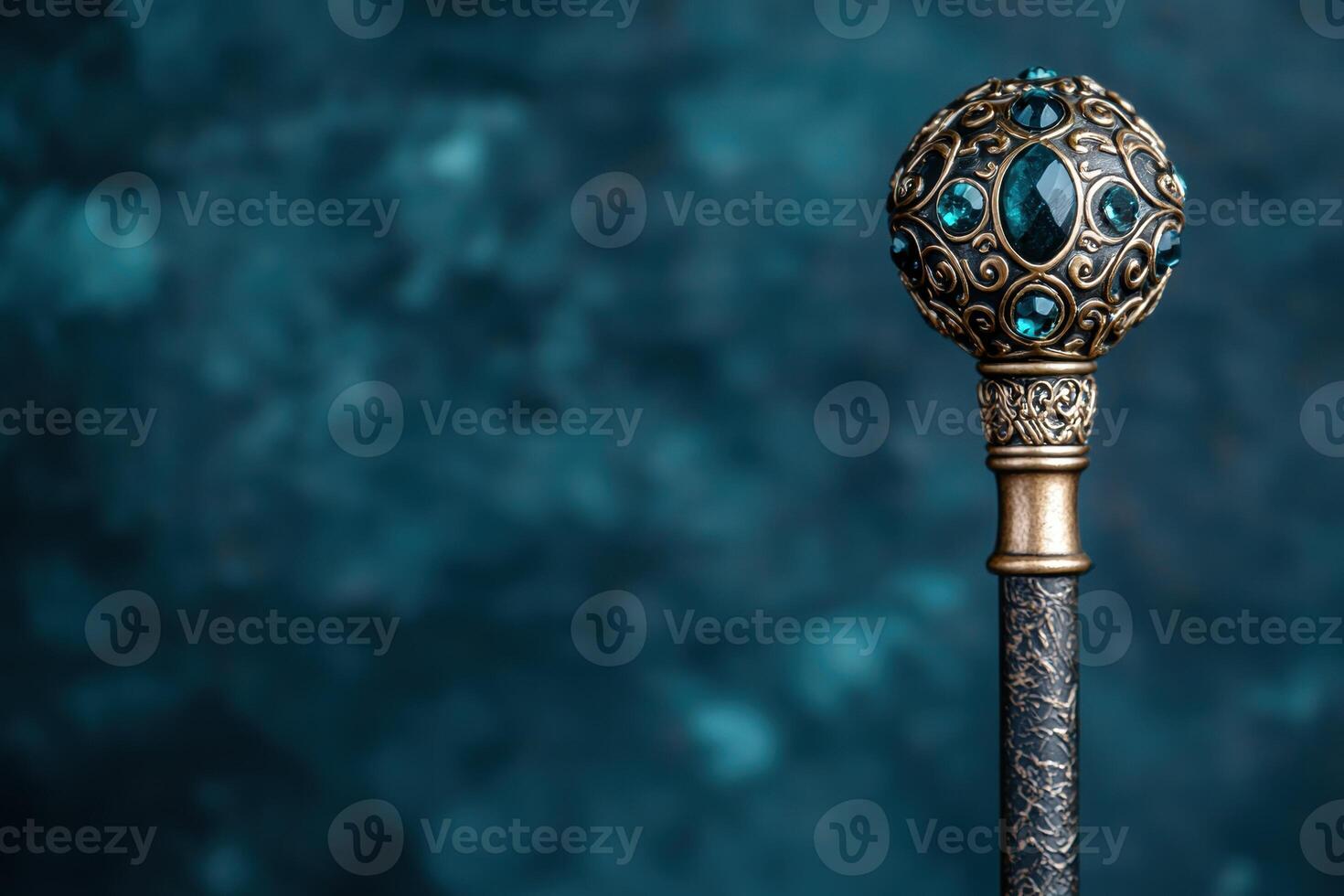 Ornate golden scepter with blue gems on a dark background photo