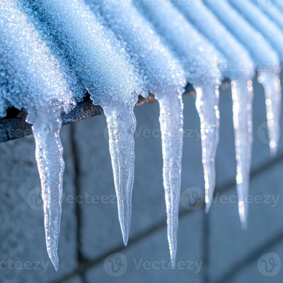 Icicles hanging from a surface in a winter scene photo