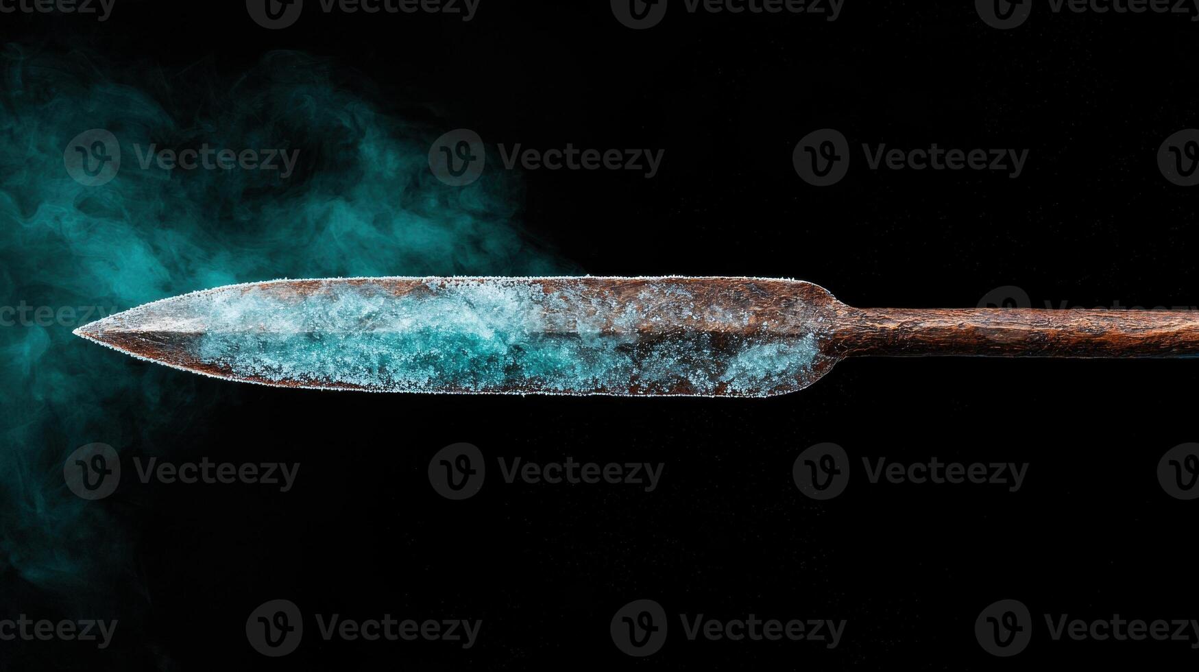 Frozen ancient dagger against dark background photo