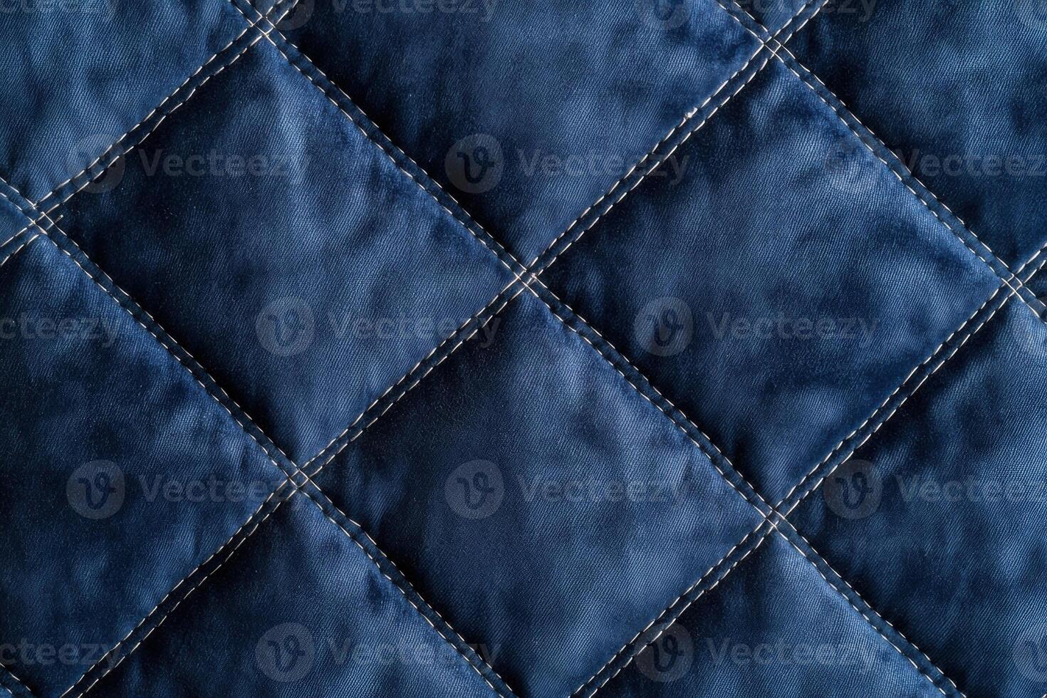 Textured quilted fabric with stitched diamond pattern photo