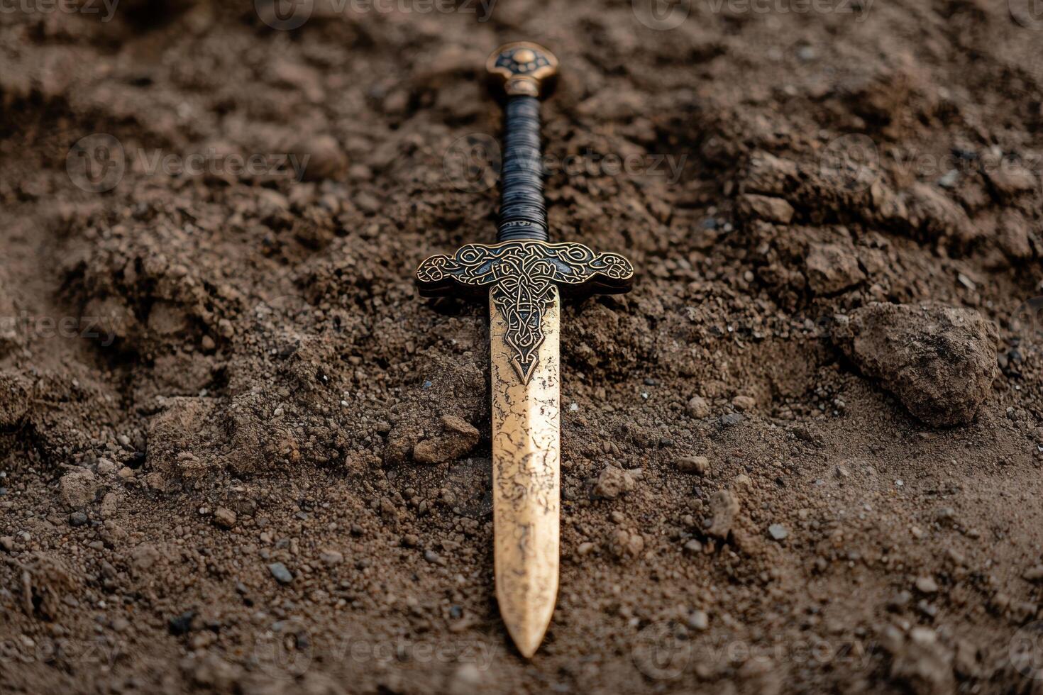 Ornate sword embedded in the ground photo