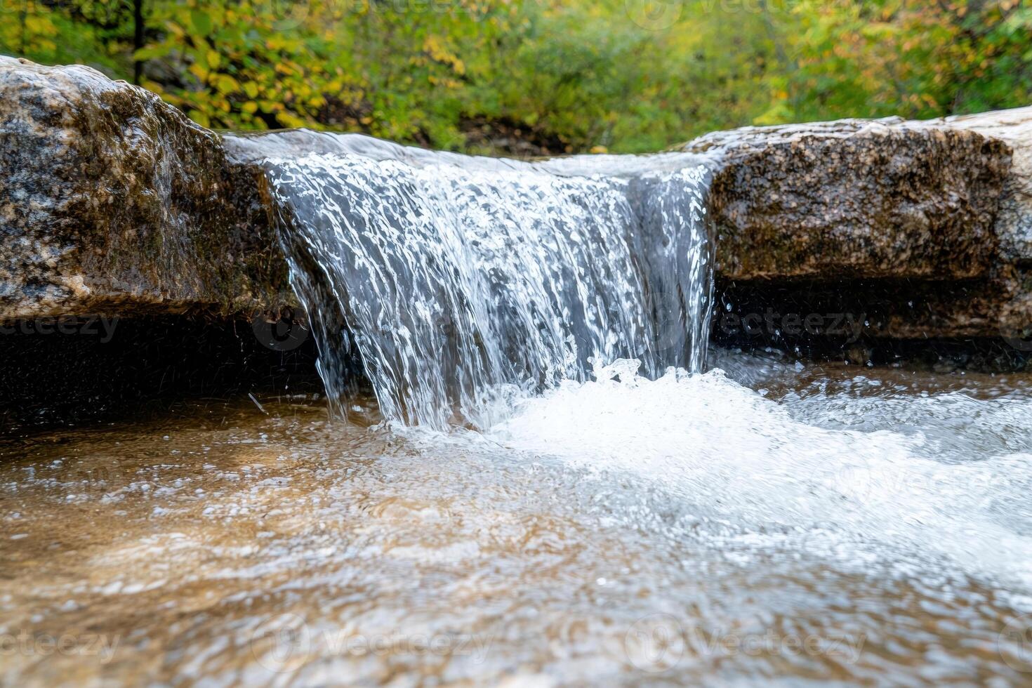 Flowing waterfall in lush forest landscape photo
