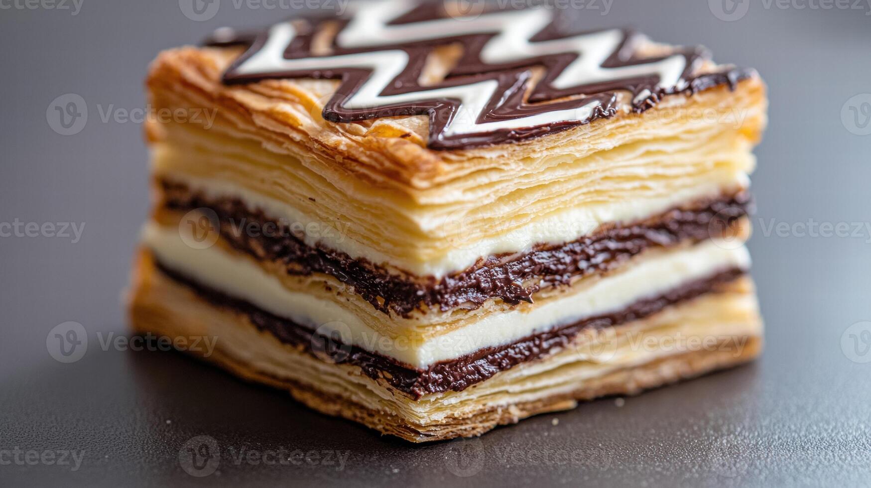 Delicious layered pastry dessert with chocolate zig zag design photo