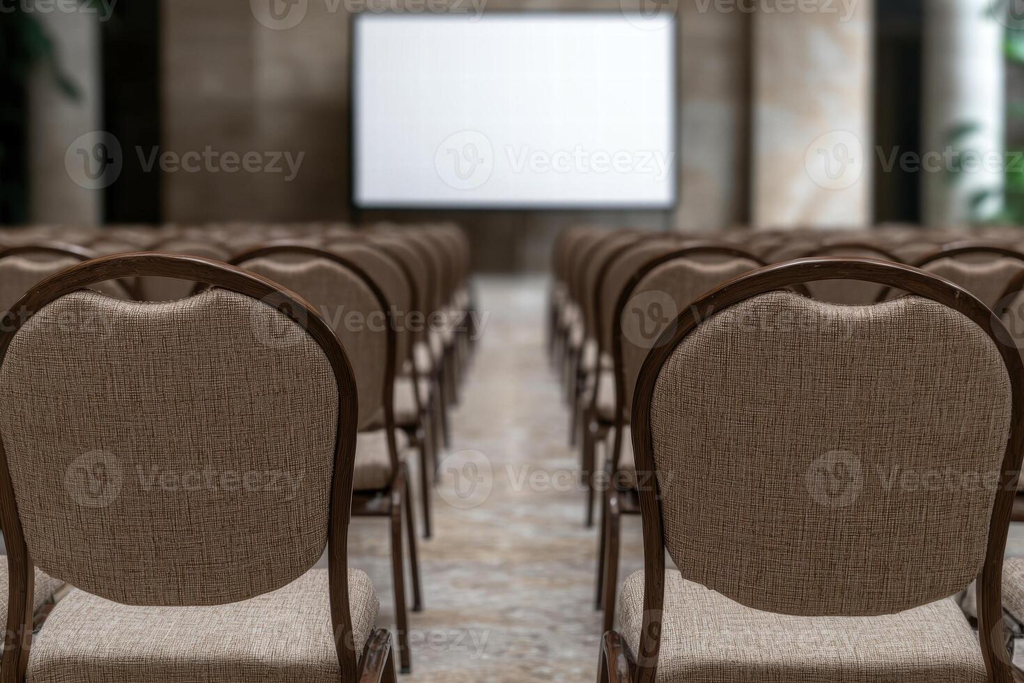 empty auditorium with rows of chairs and projection screen photo