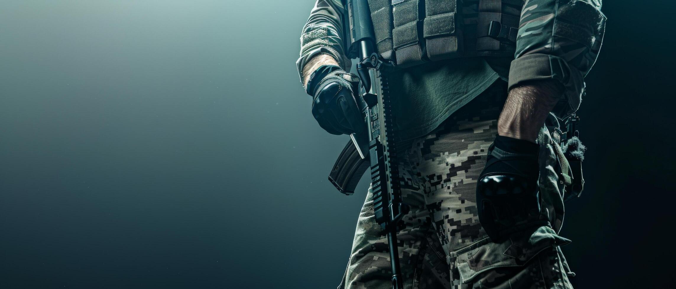 A soldier in full combat gear is standing in a dark room. He is holding a gun and looking to the side. photo