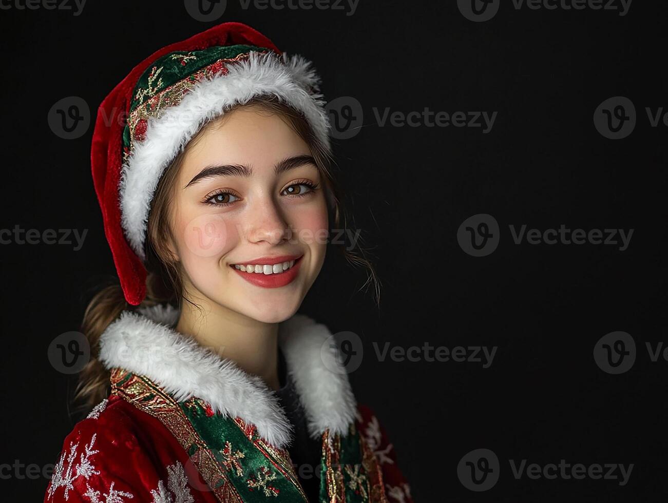 A girl in a santa hat smiling photo