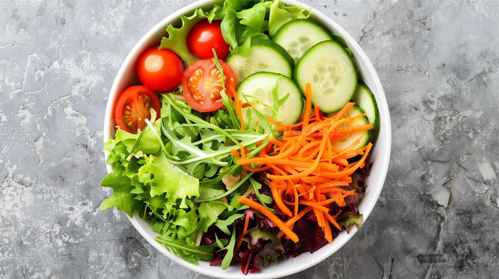 Bowl of mixed greens cherry tomatoes cucumber slices shredded carrots vinaigrette, photography photo