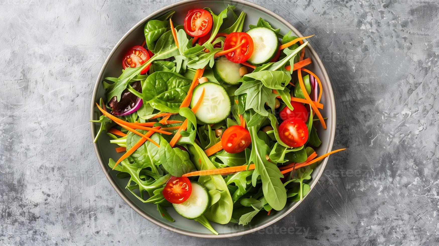 Bowl of mixed greens cherry tomatoes cucumber slices shredded carrots vinaigrette, photorealistic photo