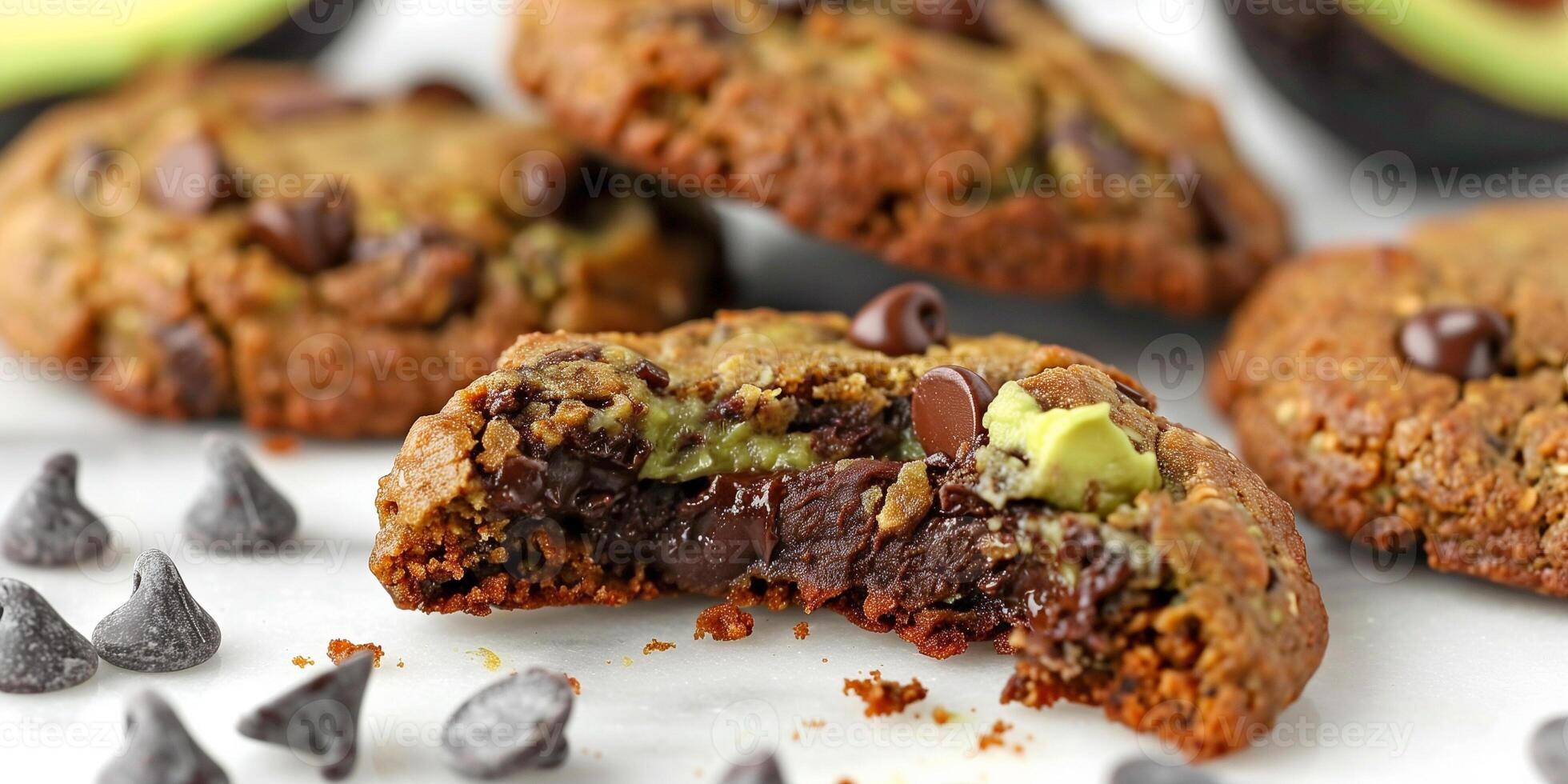 Close-up of a keto-friendly avocado chocolate chip cookie with a bite taken out, photo