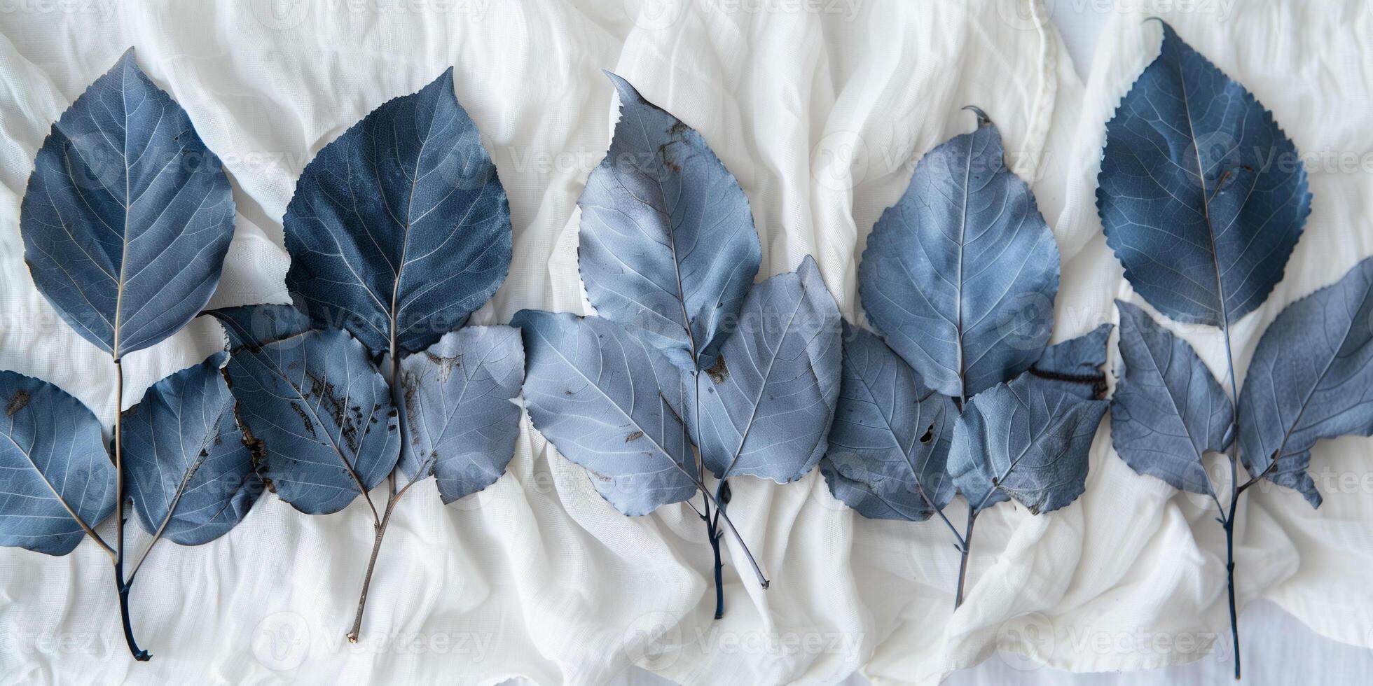 Freshly picked indigo leaves arranged on white cloth for fermentation process, photorealistic photo