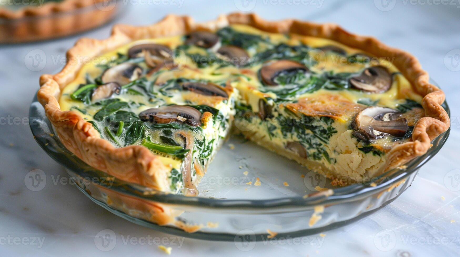 Dairy-free spinach and mushroom quiche with golden-brown crust sliced to show creamy filling, photo