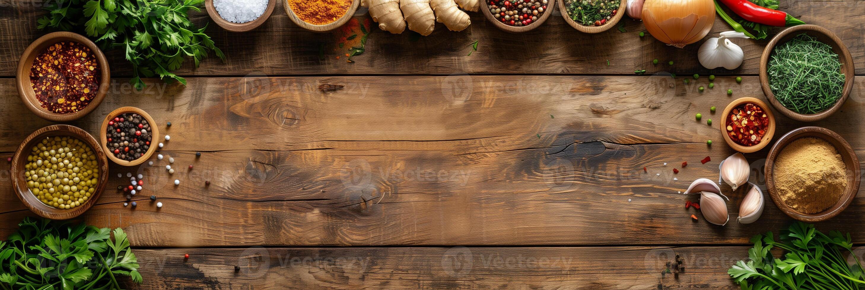 High-definition image of wooden kitchen table with ingredients including onions, fresh ginger, garlic, red chili powder, turmeric powder, top down view, photo