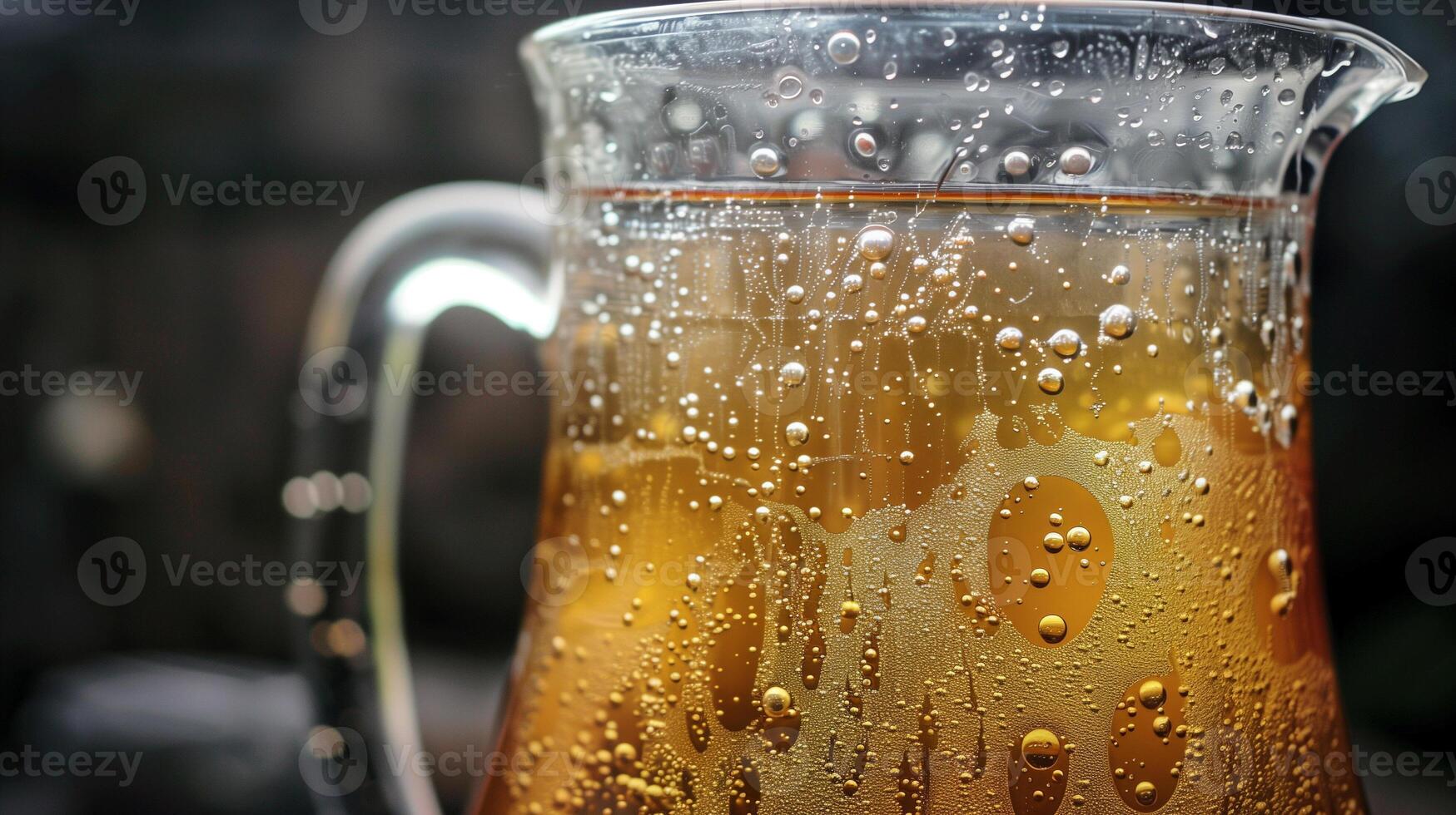 A large glass jug with fermenting ginger beer showing bubbling action at the surface, picture photo