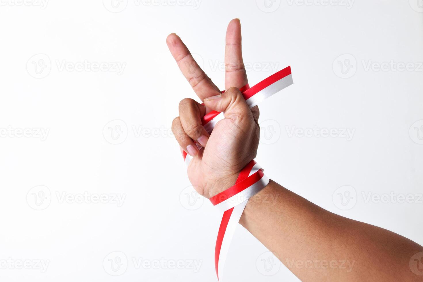 Two-finger greeting or peace with a red and white ribbon photo