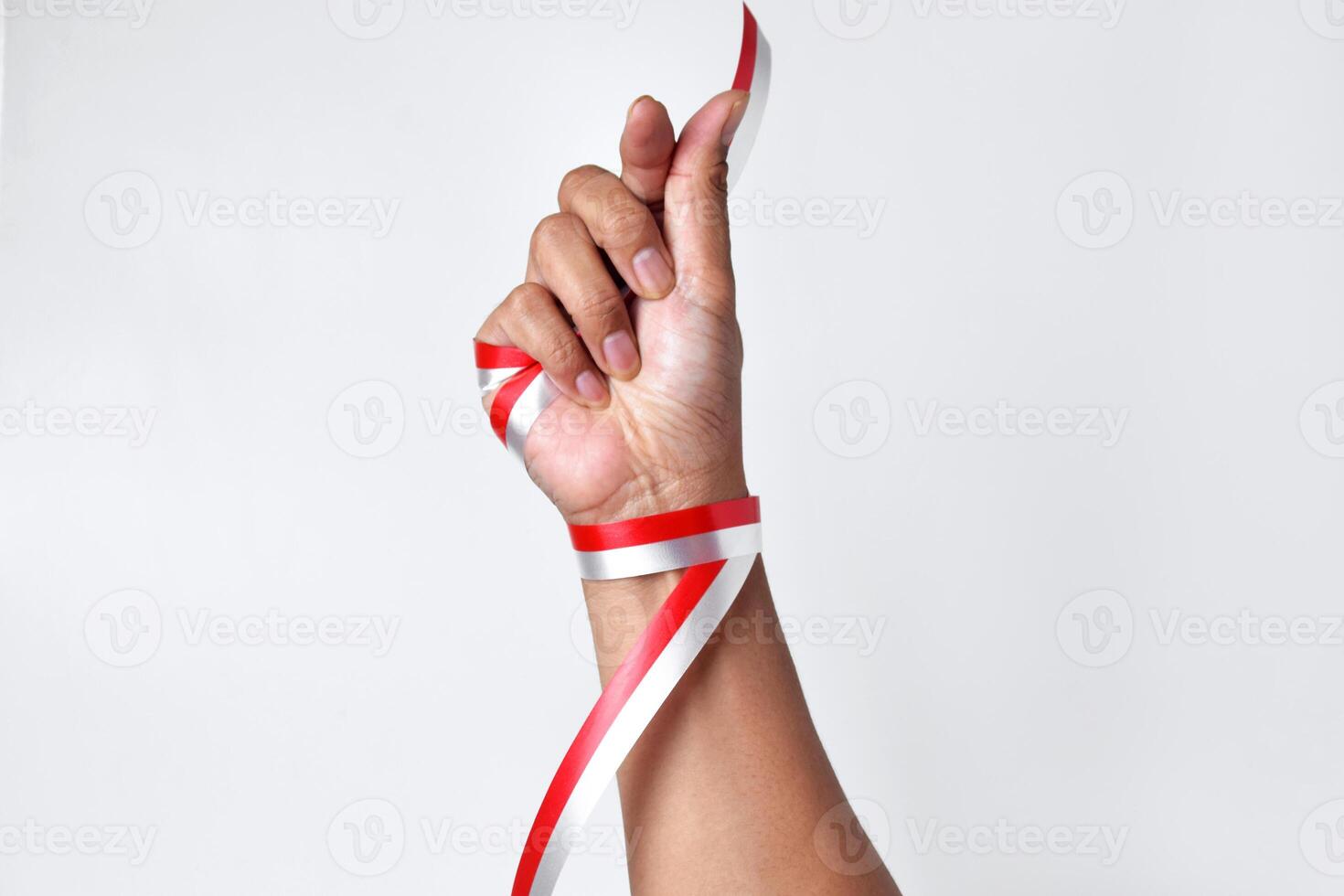 Greetings of love with two fingers circled by a red and white ribbon photo