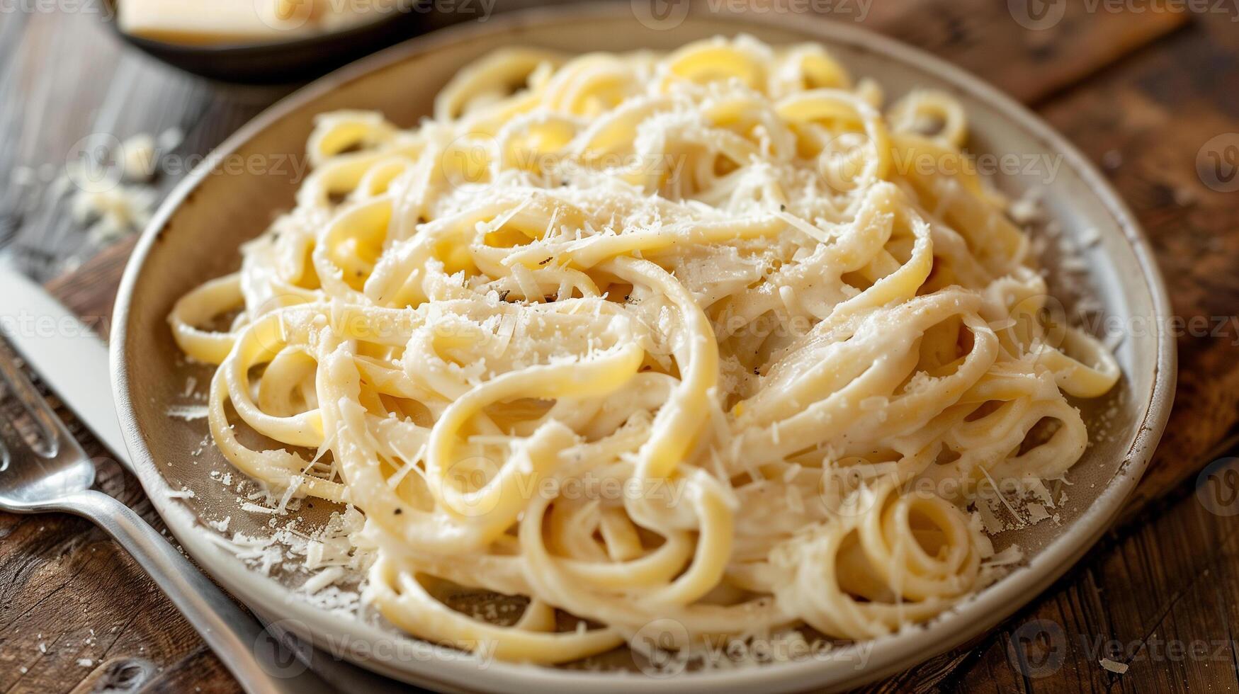 Plate of linguine pasta tossed in creamy Alfredo sauce with freshly grated Parmesan cheese, photography photo