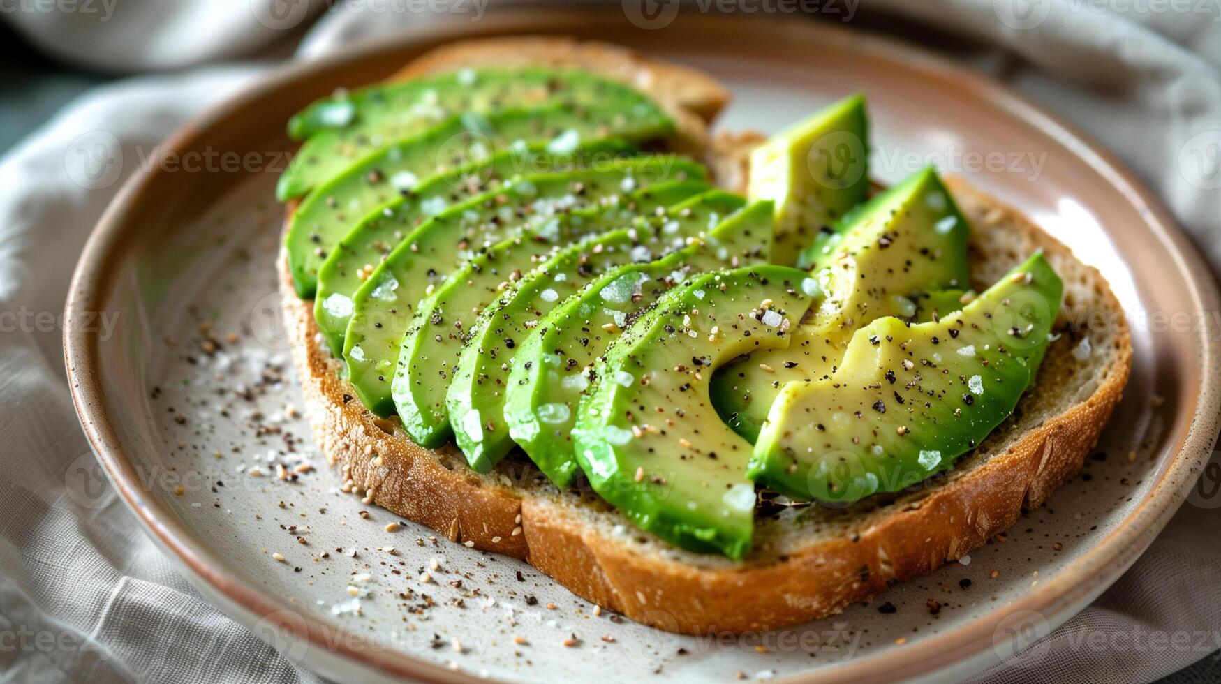 Simple avocado toast on whole grain bread with salt and pepper, photo