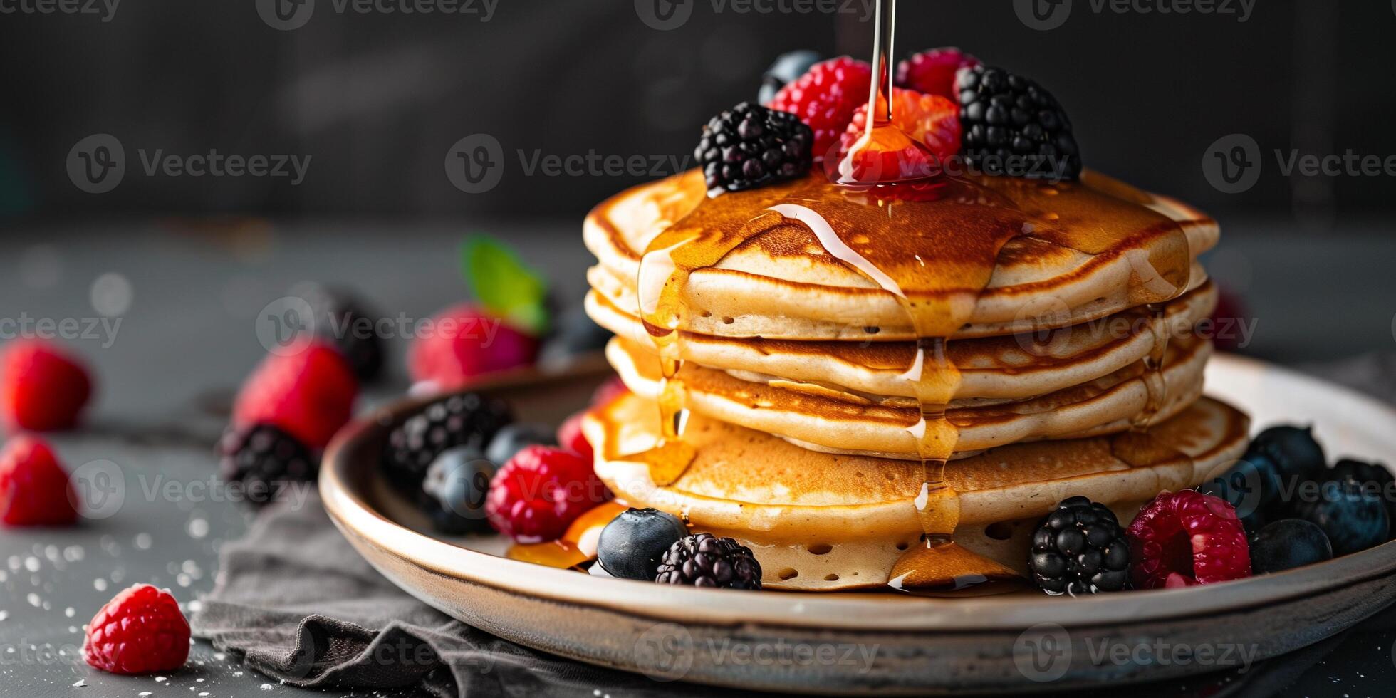 Stack of plant-based pancakes with mixed berries and maple syrup drizzle, picture photo