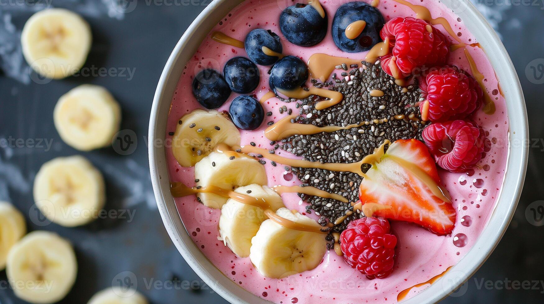 Vibrant smoothie bowl topped with fresh berries banana chia seeds and almond butter, picture photo