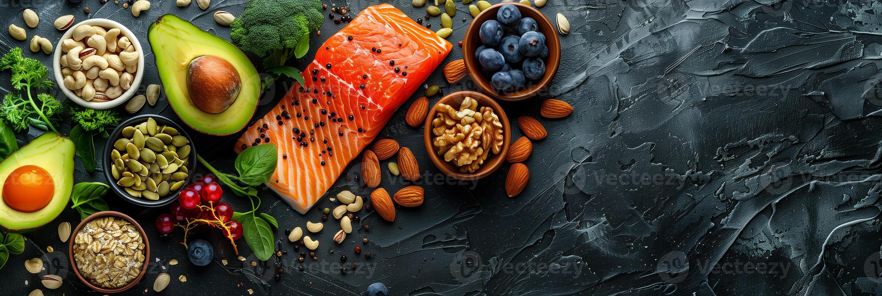 Aerial view of healthy food including avocado, broccoli, salmon, nuts, oatmeal, berries, eggs, vegetables, picture photo