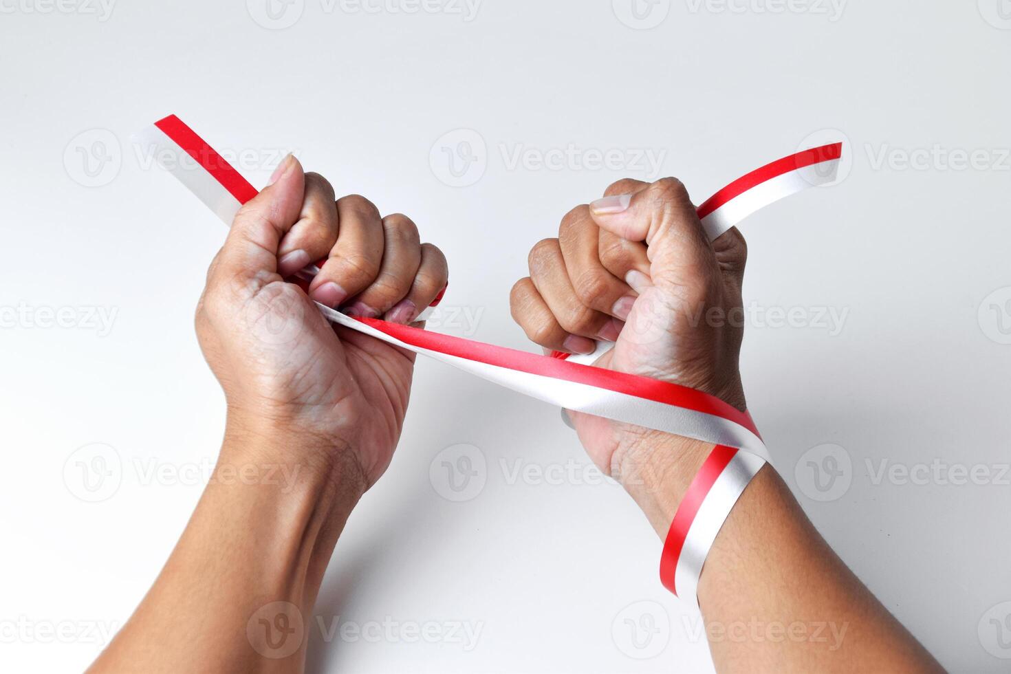Hands clasped enthusiastically with a red and white ribbon wrapped photo