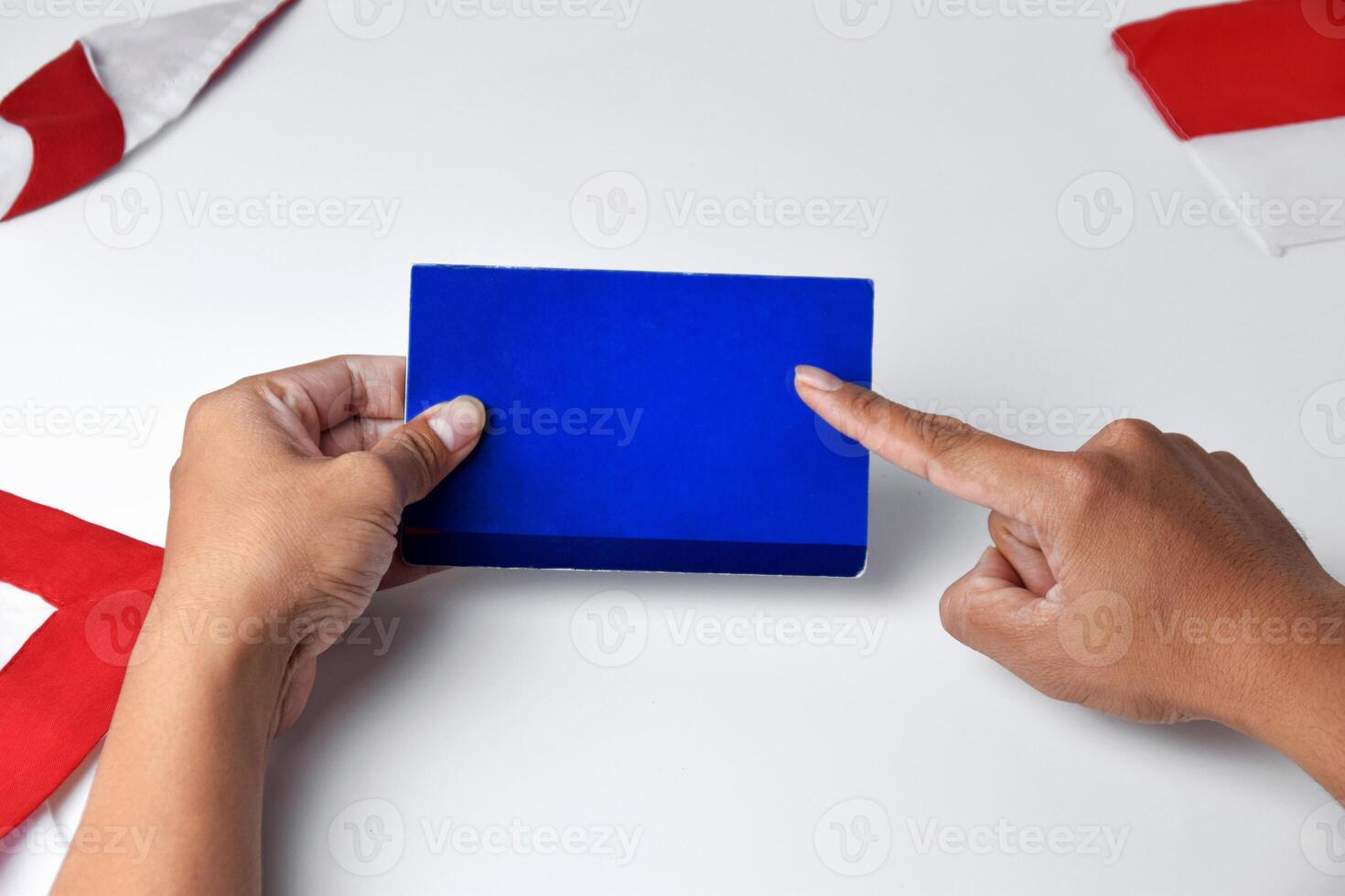 A person holds and shows a blue savings account book photo