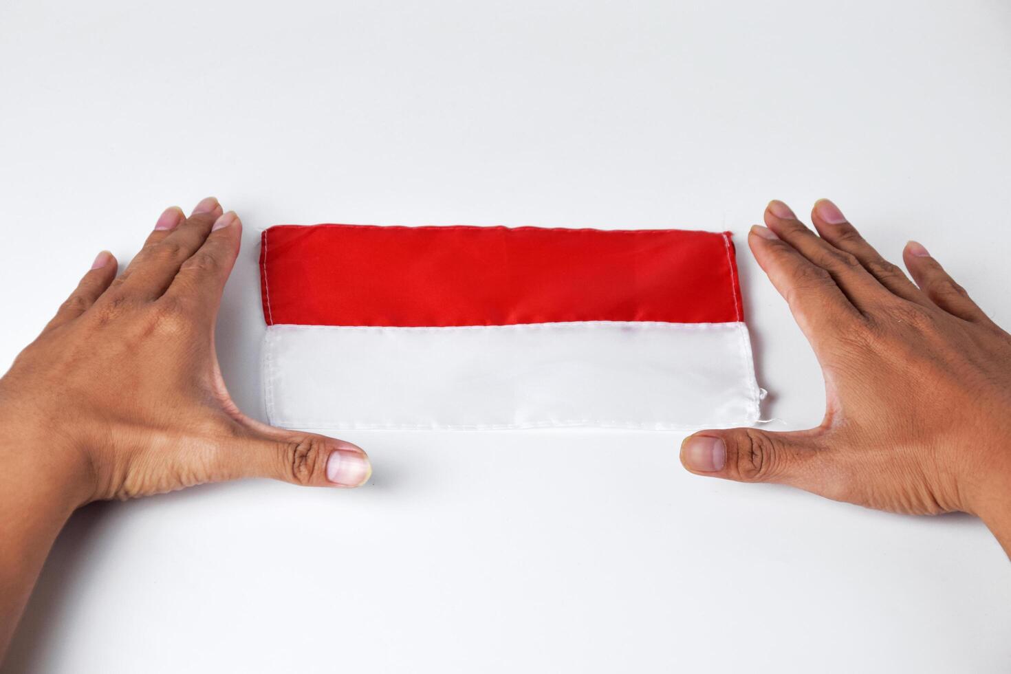 Hands enthusiastically show the red and white flag photo