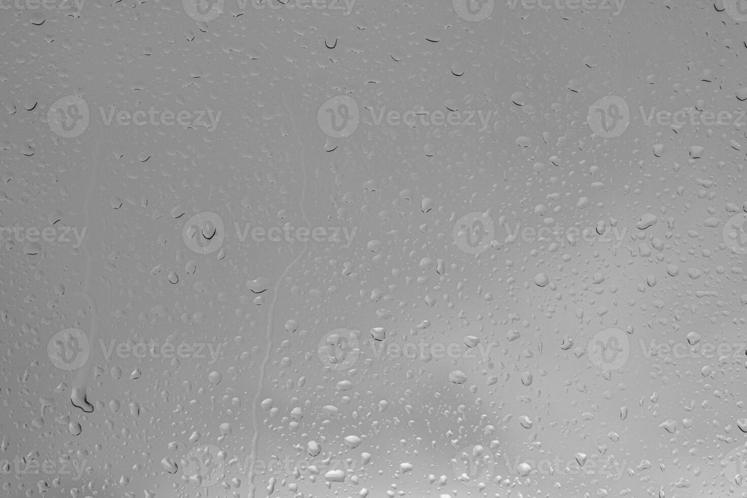 Rain drops on a window indicating gray and rainy day photo