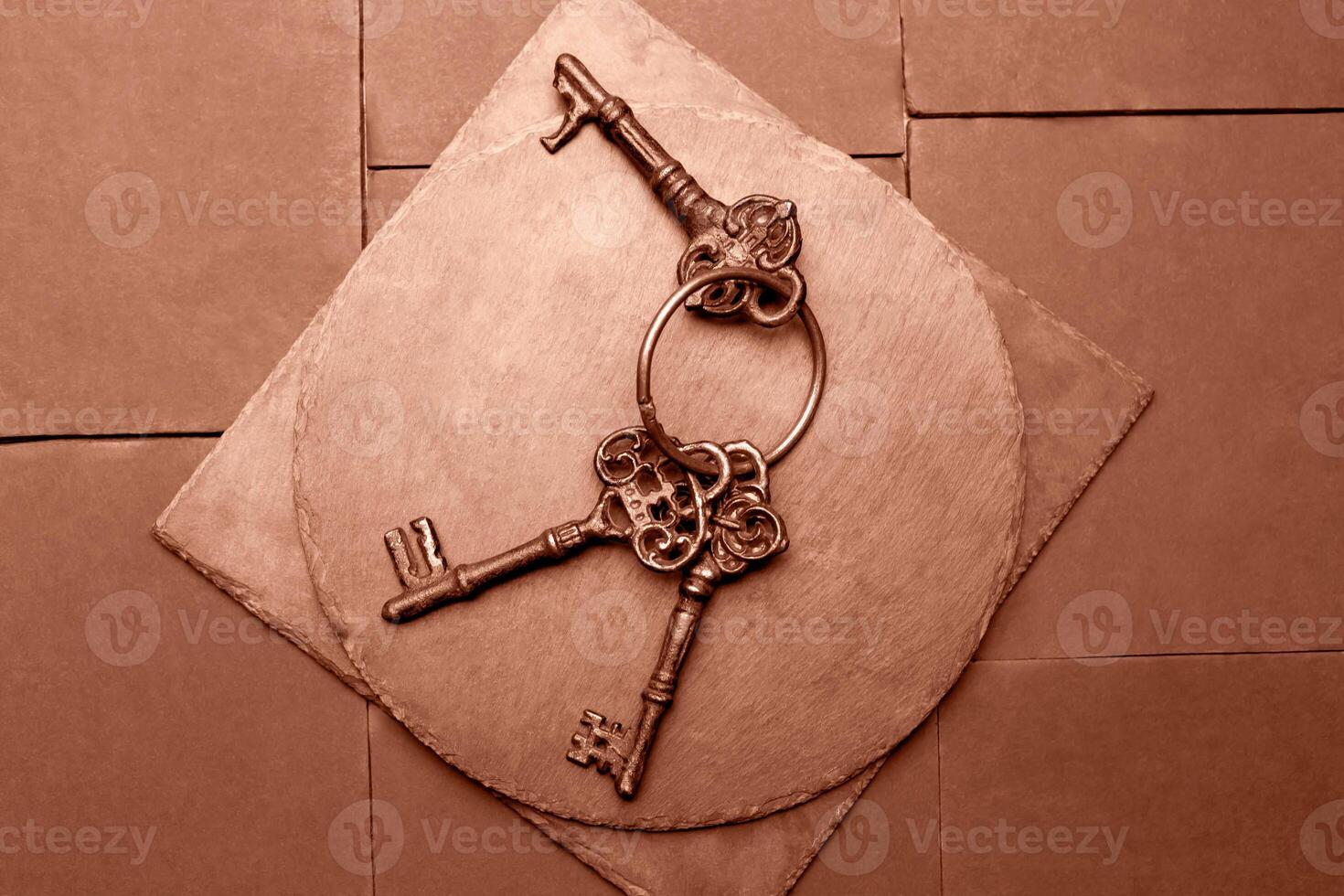 Three old keys on Mocha brown plates photo