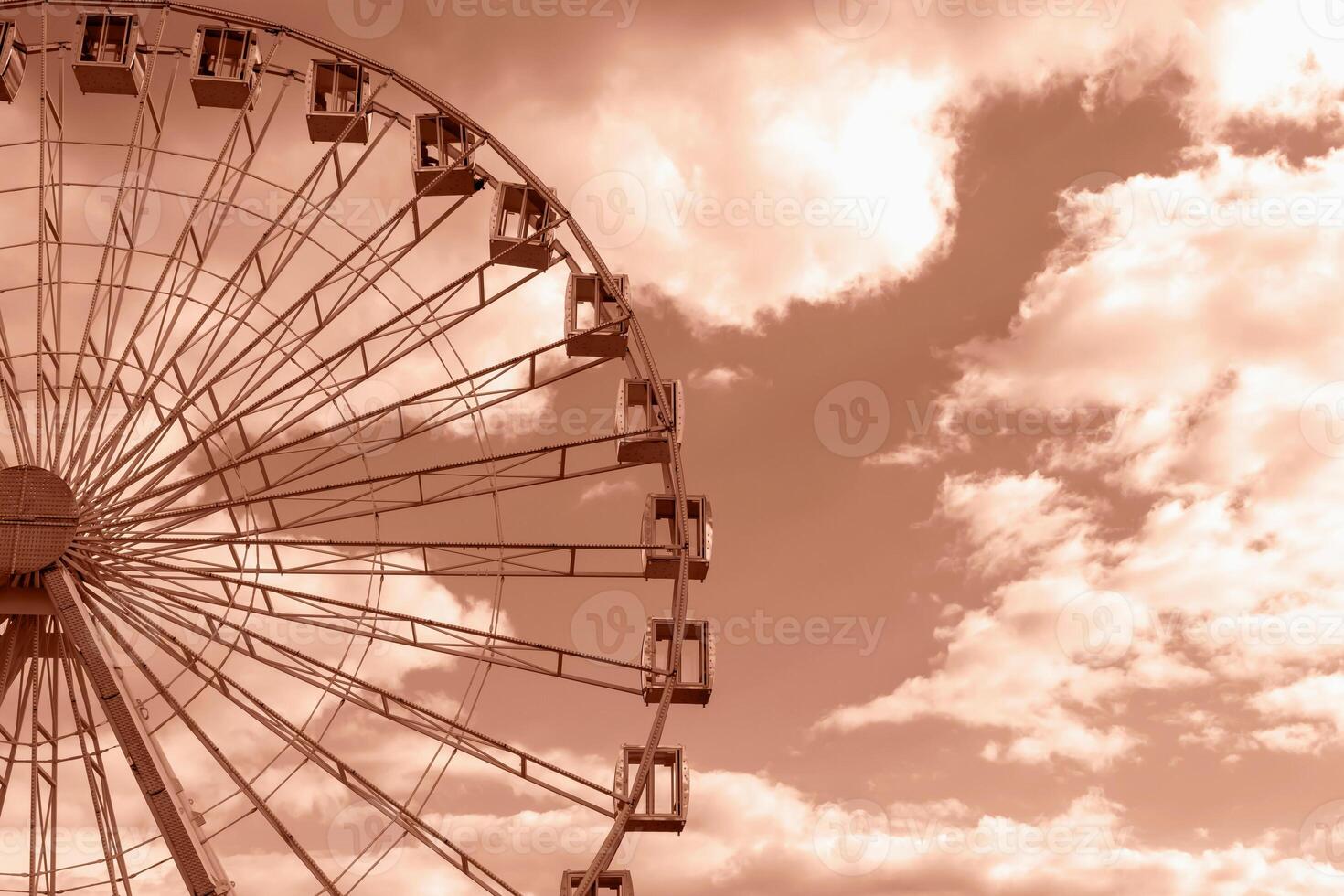 Big round Ferris wheel on background of sky with clouds. Natural Mocha brown background with copy space. Concept of growth. Demonstrating color of 2025 year photo