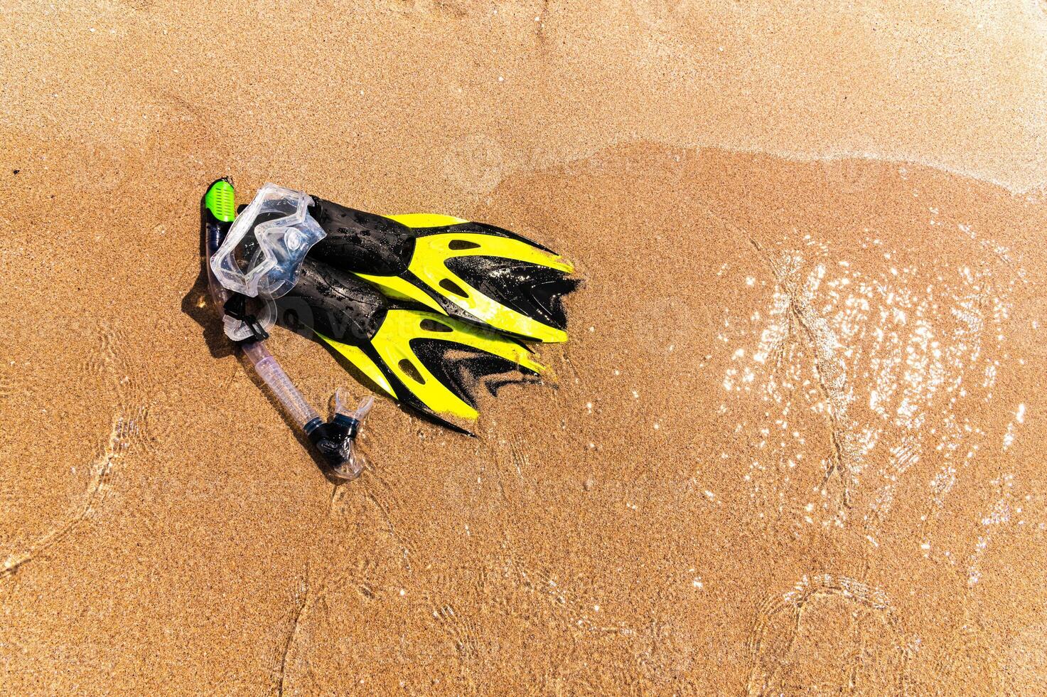 dive equipment on gold sand beach in the sea shore photo