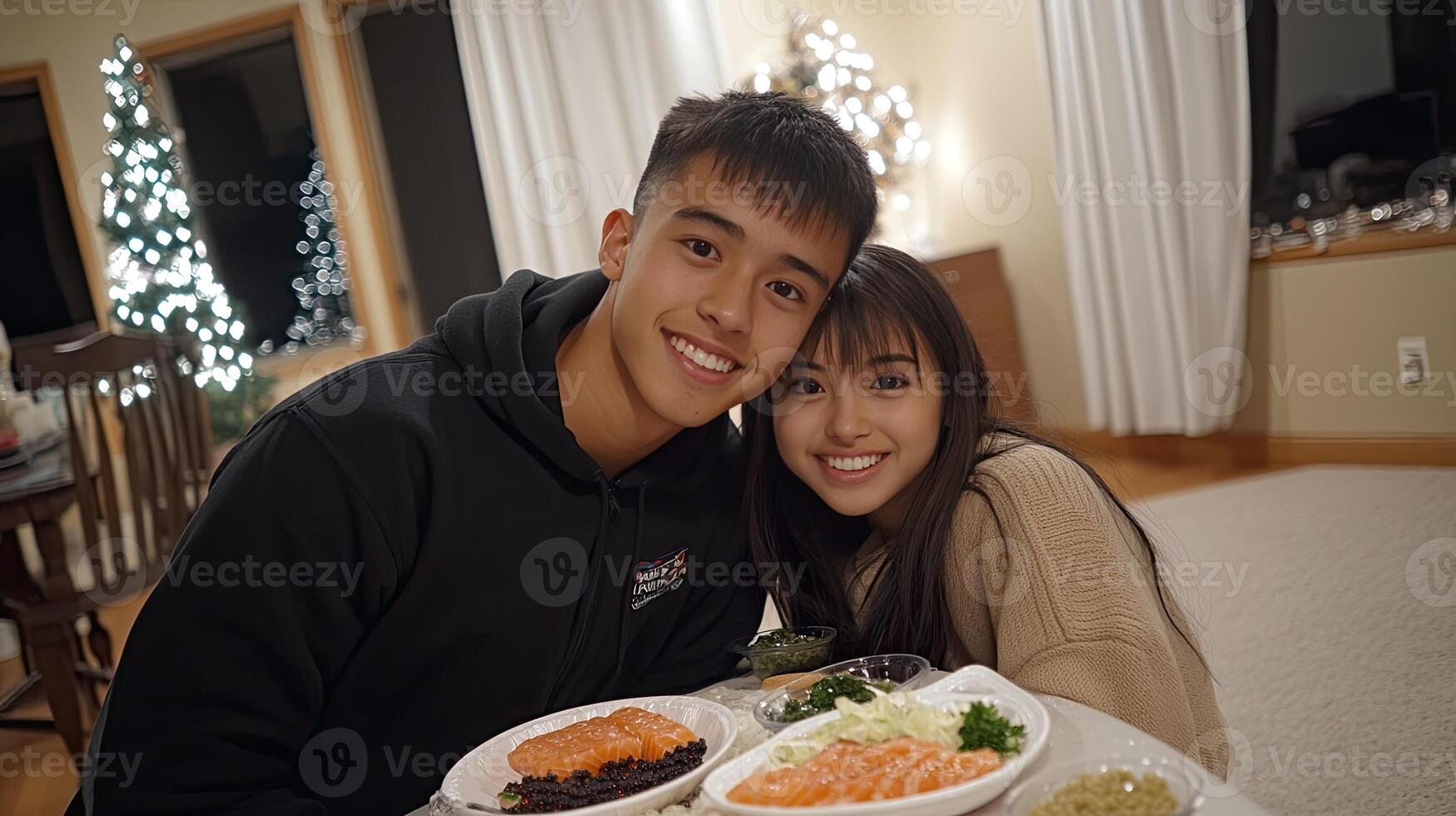 A young couple posing for a photo with food on a table