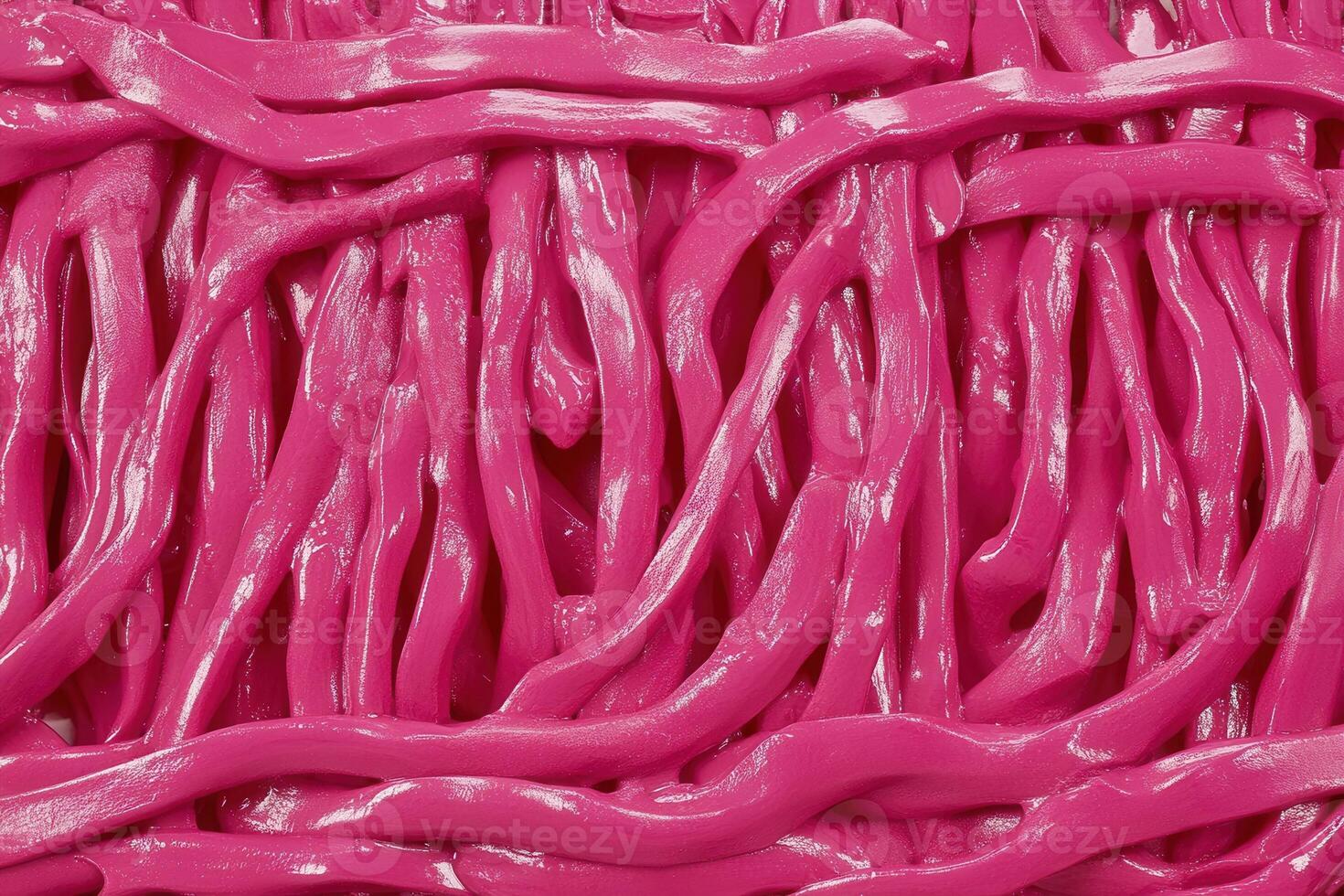 Close-up of vibrant pink, twisted strands resembling candy. photo