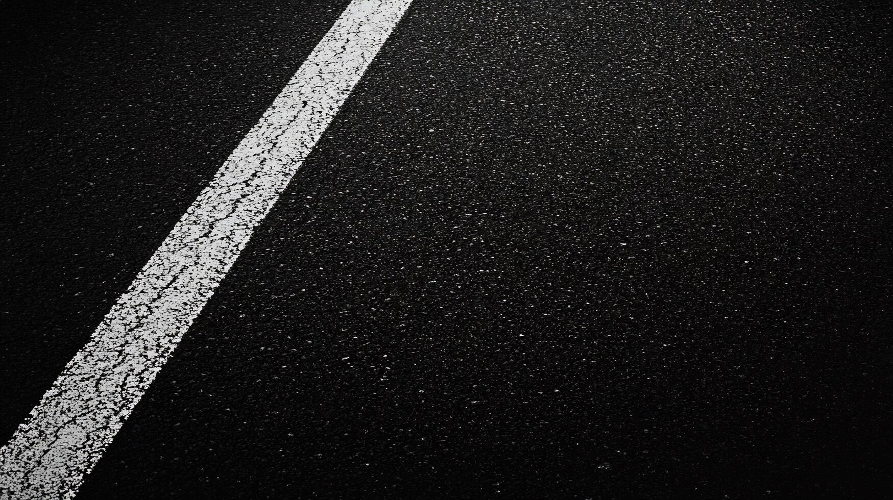 Black and white photo of a road with white lines