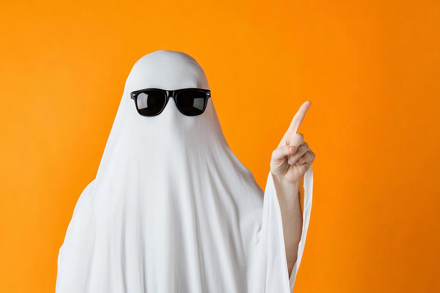 A person in a ghost costume with sunglasses and a white sheet photo