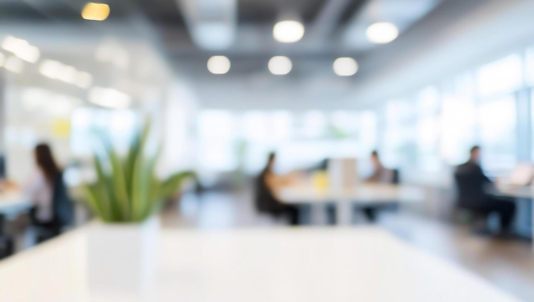 Blurred image of office with people working at desks photo