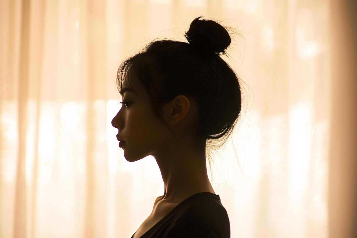 A woman with a bun in her hair photo
