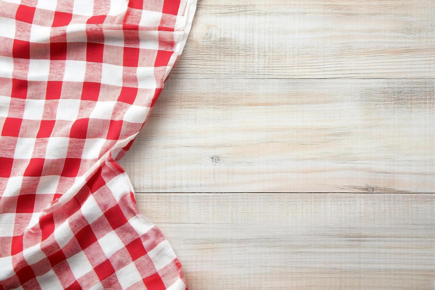Red and white checkered tablecloth on wooden table photo