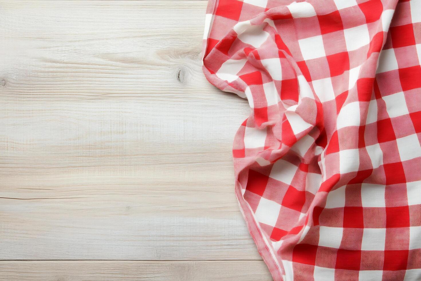 Red and white checkered tablecloth on wooden table photo