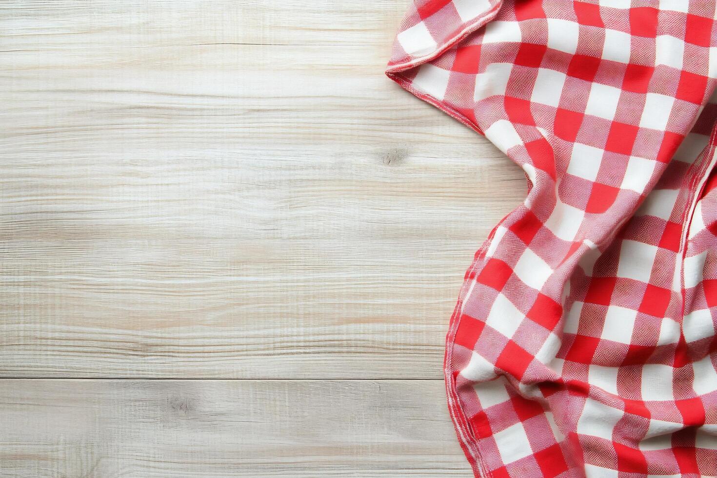 Red and white checkered tablecloth on wooden table photo