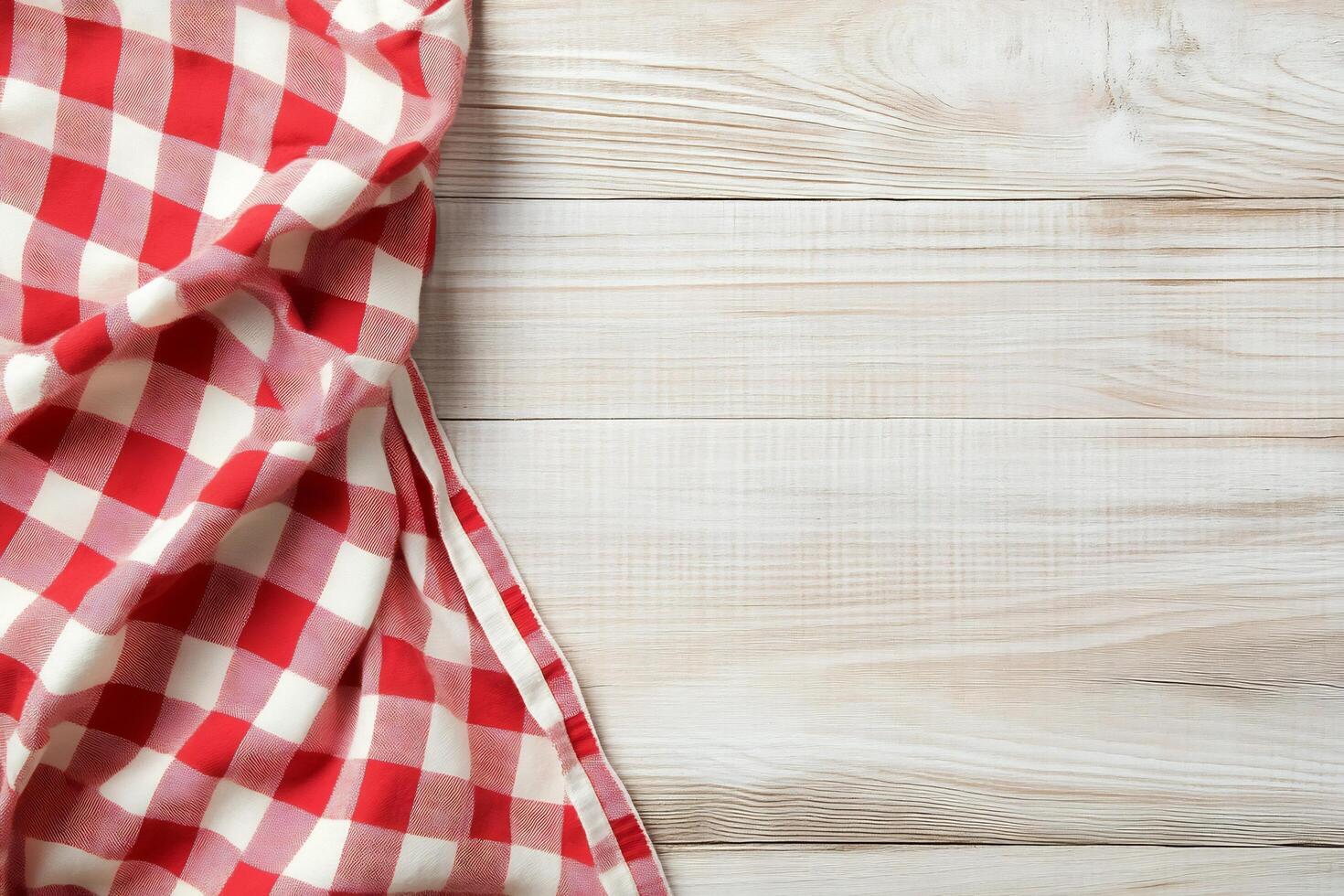 Checkered red and white tablecloth on wooden background photo