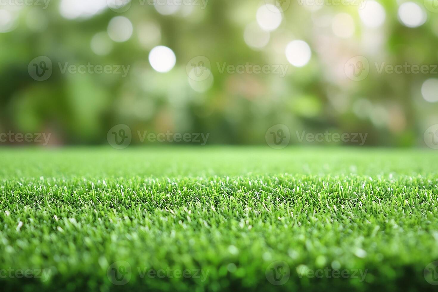 Artificial grass background with bokeh effect photo