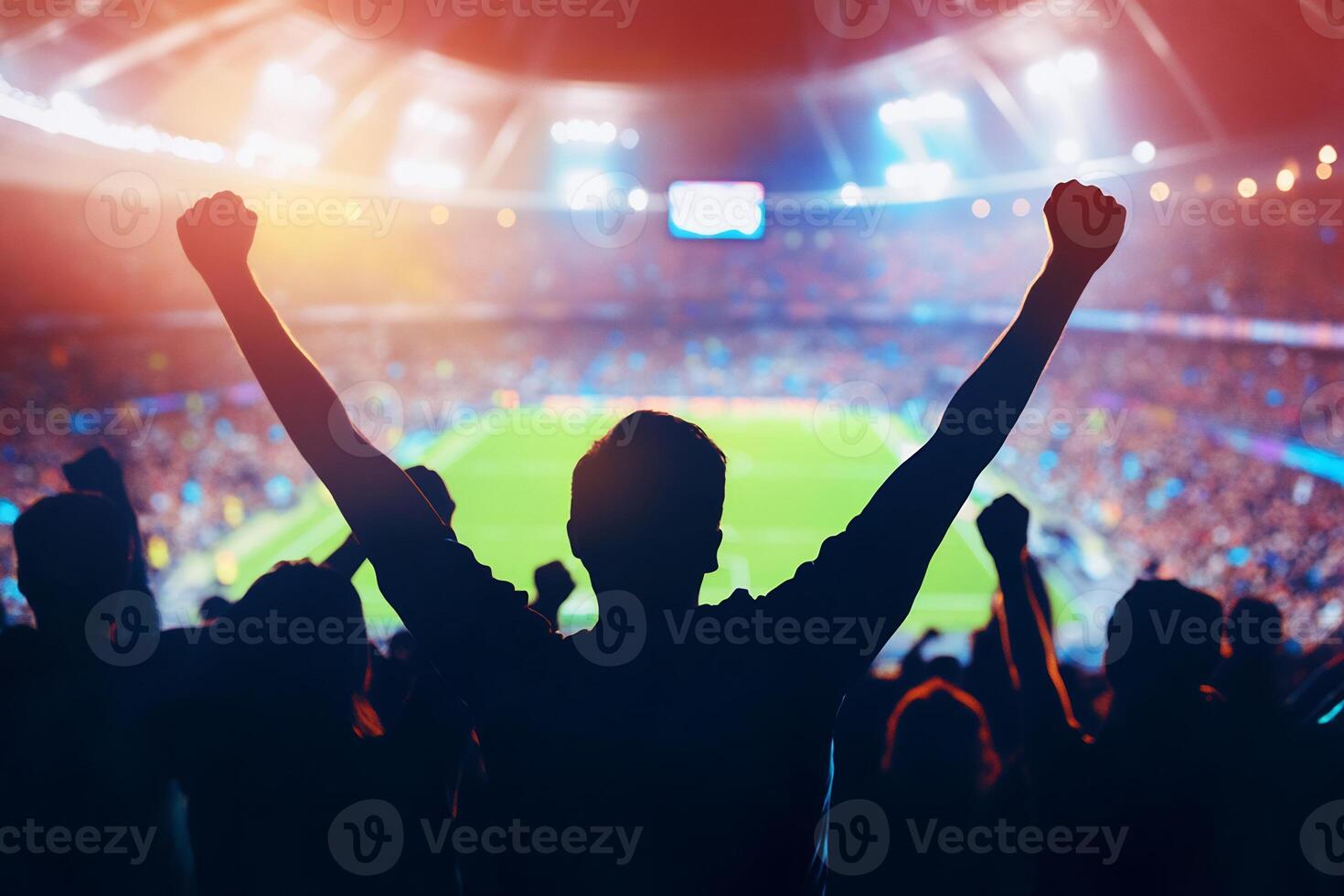 Silhouette of a soccer fan with arms raised in the air photo