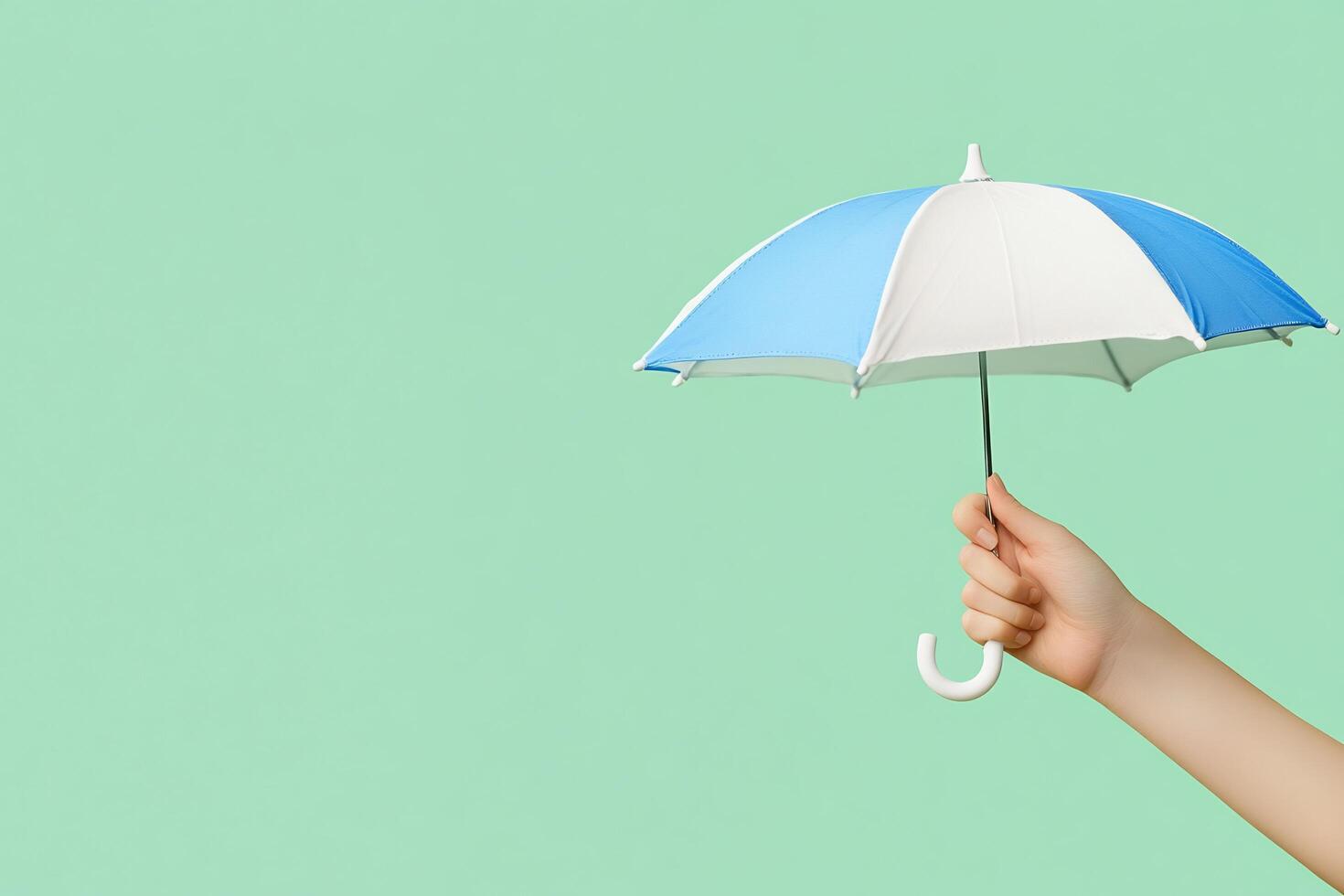 A person holding an umbrella over a green background photo
