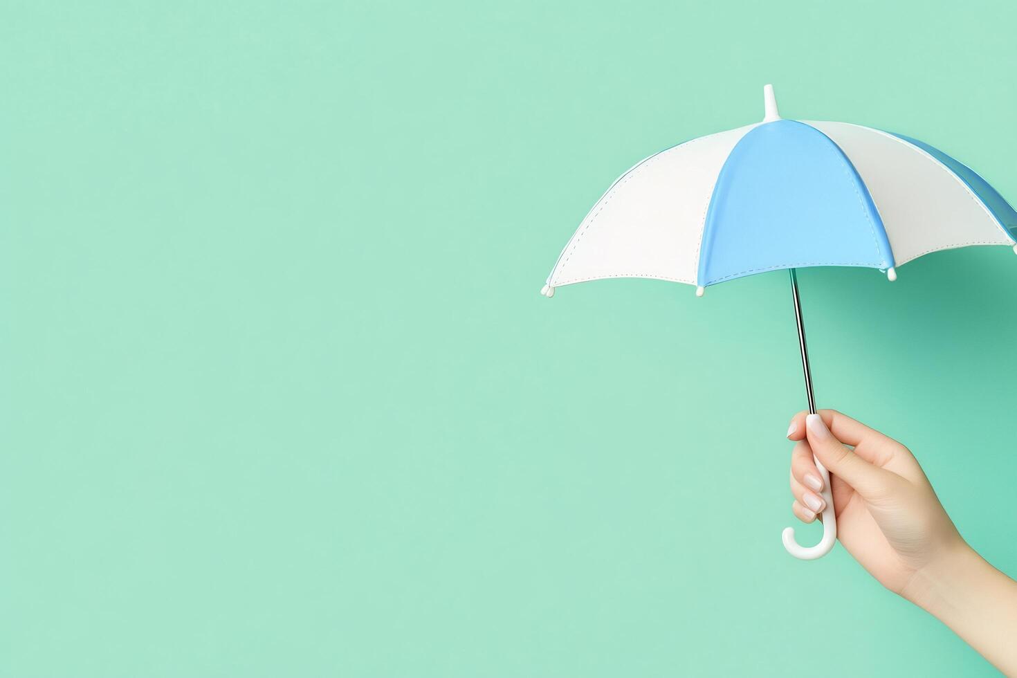 A person holding an umbrella over a green background photo