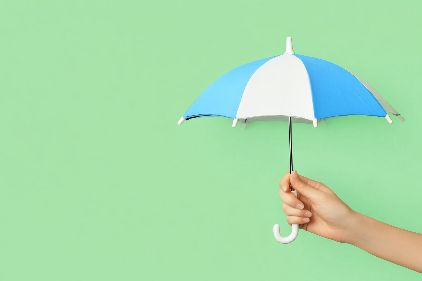 A person holding an umbrella over a green background photo