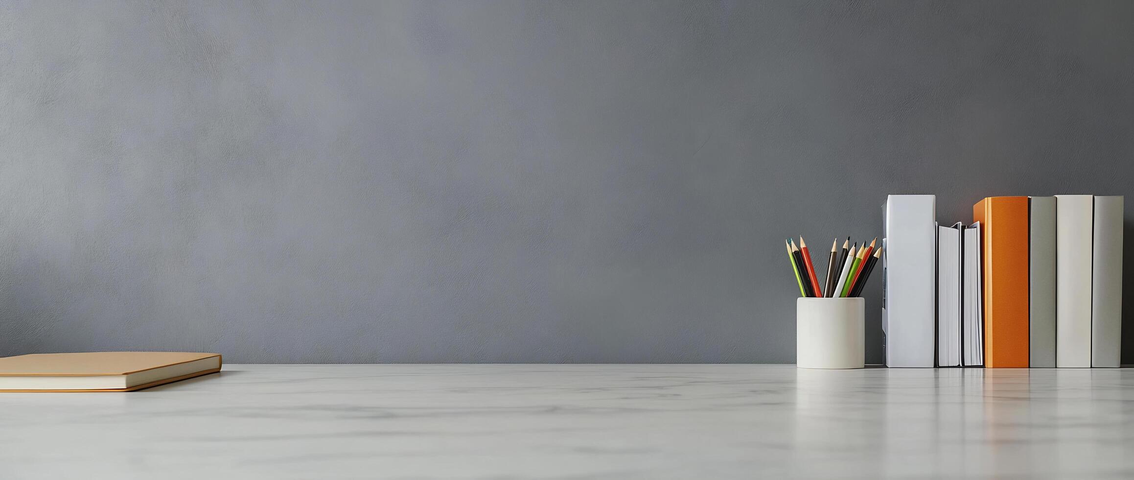 A desk with books, pencils and a notebook photo